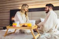 Happy couple having breakfast in luxury hotel room Royalty Free Stock Photo