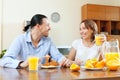 Happy couple having breakfast with oranges juice