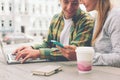 Happy couple having coffee break together and using smartphone Royalty Free Stock Photo