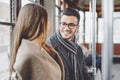 Happy couple having conversation while going to work in bus - Young people traveling in vintage tram transportation Royalty Free Stock Photo