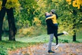 Happy Couple Having Fun in Autumn Park. Yellow Trees and Leaves. Laughing Man and Woman outdoor. Freedom Concept. Royalty Free Stock Photo