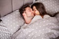 Happy couple having fun in bed. Intimate sensual young couple in bedroom enjoying each other