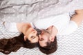 Happy couple having fun in bed. Intimate sensual young couple in bedroom enjoying each other