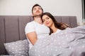 Happy couple having fun in bed.Young couple in bedroom enjoying each other.