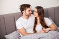 Happy couple having fun in bed.Young couple in bedroom enjoying each other.