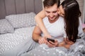 Happy couple having fun in bed.Young couple in bedroom enjoying each other.