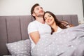 Happy couple having fun in bed.Young couple in bedroom enjoying each other.