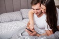 Happy couple having fun in bed.Young couple in bedroom enjoying each other.