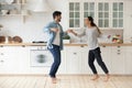Happy active young couple husband and wife dancing in kitchen Royalty Free Stock Photo