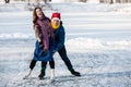 Happy couple having fun ice skating on rink outdoors. Royalty Free Stock Photo