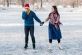 Happy couple having fun ice skating on rink outdoors Royalty Free Stock Photo