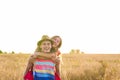 Happy Couple Having Fun Outdoors on wheat field. Freedom Concept. Piggyback Royalty Free Stock Photo