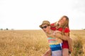 Happy Couple Having Fun Outdoors on wheat field. Freedom Concept. Piggyback Royalty Free Stock Photo