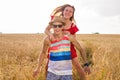 Happy Couple Having Fun Outdoors on wheat field. Freedom Concept. Piggyback Royalty Free Stock Photo