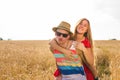 Happy Couple Having Fun Outdoors on wheat field. Laughing Joyful Family together. Freedom Concept. Piggyback Royalty Free Stock Photo