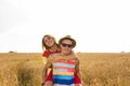 Happy Couple Having Fun Outdoors on wheat field. Laughing Joyful Family together. Freedom Concept. Piggyback Royalty Free Stock Photo