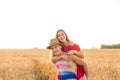 Happy Couple Having Fun Outdoors on wheat field. Laughing Joyful Family together. Freedom Concept. Piggyback Royalty Free Stock Photo