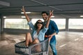 Happy Couple Having Fun With Shopping Cart At Mall Parking Royalty Free Stock Photo