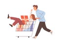 Happy couple having fun with shopping cart. Young man pushing supermarket trolley with holiday gifts and woman sitting Royalty Free Stock Photo