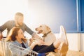 Happy couple having fun supermarket. Young man pushing shopping cart with girfriend and dog Royalty Free Stock Photo