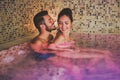 Happy couple having fun in swimming pool luxury spa resort hotel - Romantic young people doing relaxing wellness treatment