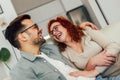 Happy couple having fun while talking about something funny at home Royalty Free Stock Photo