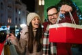 Happy couple having fun together on Christmas shopping. Holiday present people happiness concept Royalty Free Stock Photo
