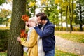 Happy Couple having fun together Outdoor in the golden autumn park. Wife and husband in love. Real people emotions