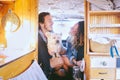 Happy couple having fun in vintage minivan with their dog during a road trip - Young people enjoying time together Royalty Free Stock Photo