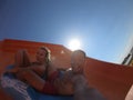 Happy couple having fun in water slides. Amusement, aqua Royalty Free Stock Photo