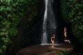 Happy couple having fun at a waterfall in Bali. A couple having fun at a waterfall in Indonesia. Travel to Asia Royalty Free Stock Photo