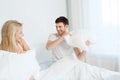 Happy couple having pillow fight in bed at home Royalty Free Stock Photo