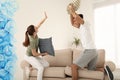 Happy couple having pillow fight in room Royalty Free Stock Photo