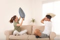 Happy couple having pillow fight in room Royalty Free Stock Photo
