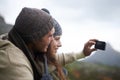 Happy couple, hiking selfie and mountains for travel, journey and adventure with photography and memory of love. People