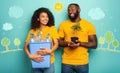 Happy couple hold a plastic container with bottles and a small tree over a light blue color. Concept of ecology Royalty Free Stock Photo