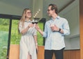 Happy couple holding glasses with red wine and celebrating Royalty Free Stock Photo