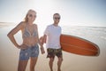 Happy couple holding hands at beach during sunny Royalty Free Stock Photo