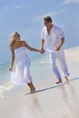 Happy Couple Holding Hands on A Tropical Beach Royalty Free Stock Photo
