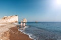 Happy couple holding hands walking on the sandy beach. Couple in love at sunset by the sea. Couple in love on vacation. Travel Royalty Free Stock Photo