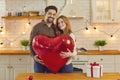 Happy couple holding huge balloon while celebrating Valentine`s Day or having anniversary party Royalty Free Stock Photo