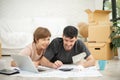 Happy couple holding money and calculating their budget Royalty Free Stock Photo