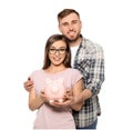 Happy couple holding piggy bank on white background. Money savings concept Royalty Free Stock Photo