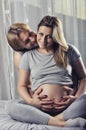 Happy couple holding pregnant belly and smile Royalty Free Stock Photo