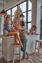 Happy couple at home kitchen. Handsome young man and woman feeding each other with cookies. Vertical photo Royalty Free Stock Photo