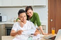 Happy couple at home paying bills with laptop Royalty Free Stock Photo