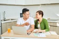 Happy couple at home paying bills with laptop Royalty Free Stock Photo