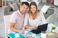 happy couple at home paying bills with laptop Royalty Free Stock Photo