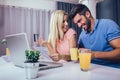 Couple at home paying bills with laptop and credit card Royalty Free Stock Photo