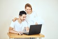 Happy couple at home paying bills with laptop Royalty Free Stock Photo